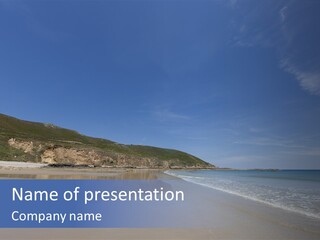 A Sandy Beach With A Hill In The Background PowerPoint Template