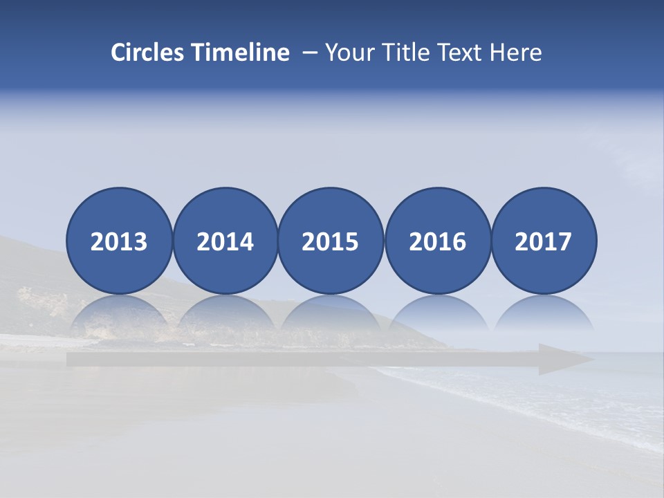 A Sandy Beach With A Hill In The Background PowerPoint Template