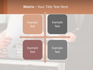 A Group Of People Sitting At A Table Writing On Paper PowerPoint Template