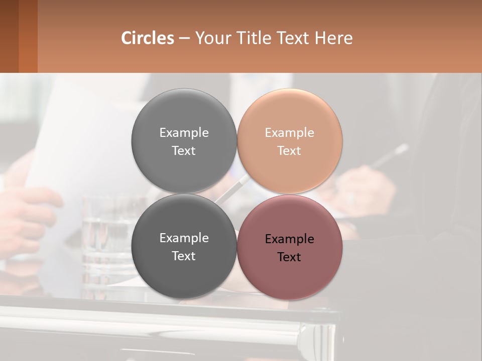 A Group Of People Sitting At A Table Writing On Paper PowerPoint Template