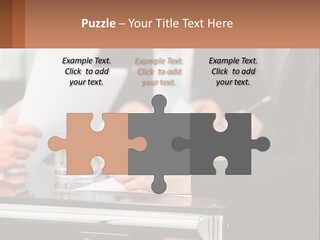 A Group Of People Sitting At A Table Writing On Paper PowerPoint Template