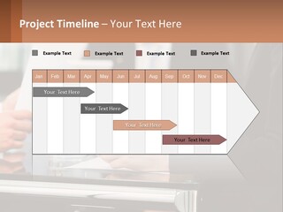 A Group Of People Sitting At A Table Writing On Paper PowerPoint Template