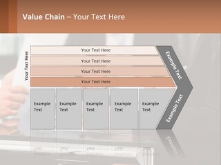 A Group Of People Sitting At A Table Writing On Paper PowerPoint Template