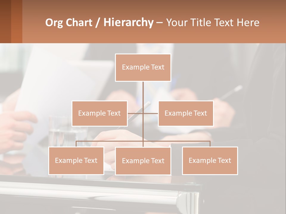 A Group Of People Sitting At A Table Writing On Paper PowerPoint Template