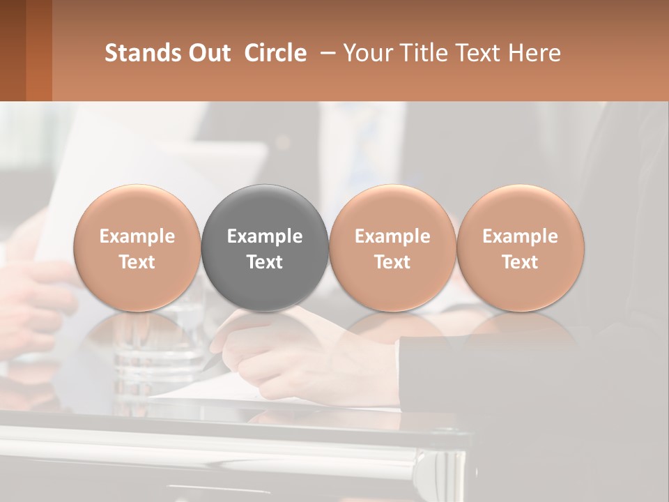 A Group Of People Sitting At A Table Writing On Paper PowerPoint Template