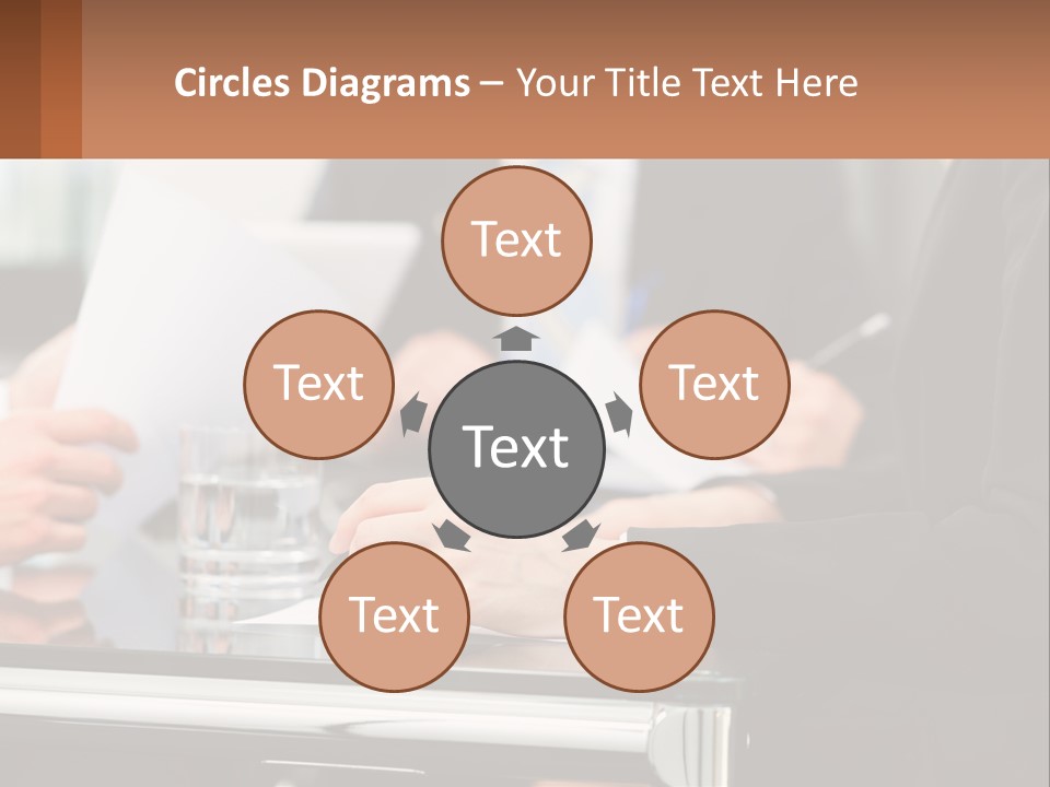 A Group Of People Sitting At A Table Writing On Paper PowerPoint Template