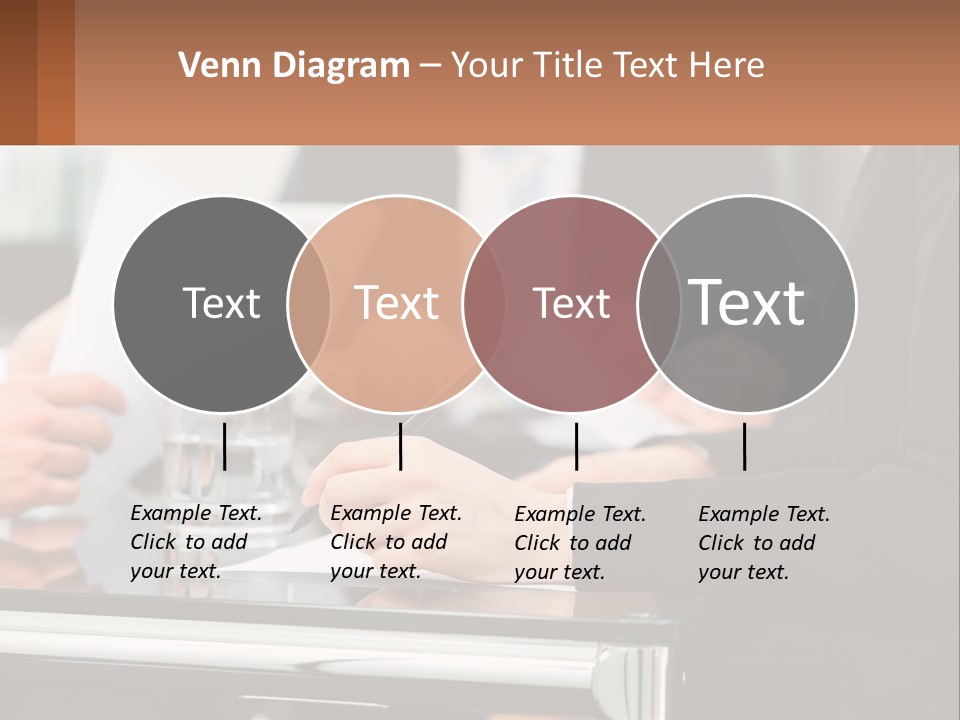 A Group Of People Sitting At A Table Writing On Paper PowerPoint Template