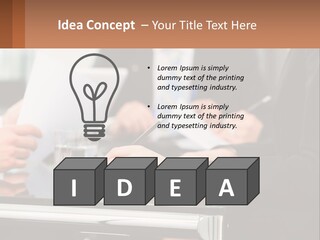 A Group Of People Sitting At A Table Writing On Paper PowerPoint Template