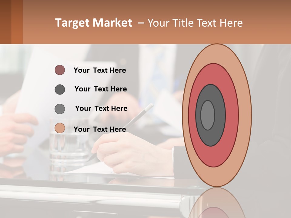 A Group Of People Sitting At A Table Writing On Paper PowerPoint Template