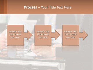 A Group Of People Sitting At A Table Writing On Paper PowerPoint Template