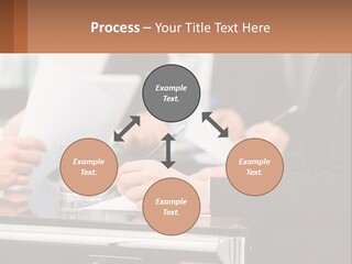 A Group Of People Sitting At A Table Writing On Paper PowerPoint Template