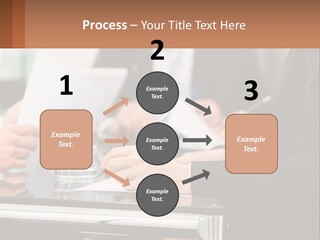 A Group Of People Sitting At A Table Writing On Paper PowerPoint Template