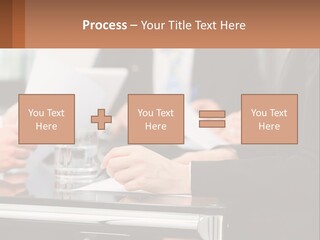 A Group Of People Sitting At A Table Writing On Paper PowerPoint Template