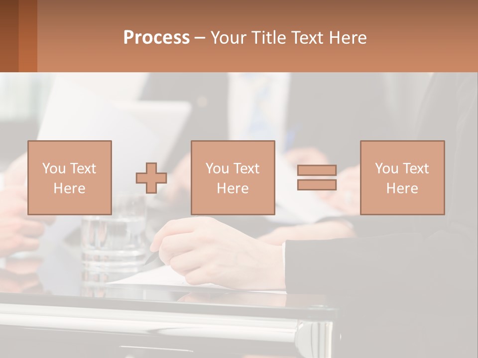 A Group Of People Sitting At A Table Writing On Paper PowerPoint Template
