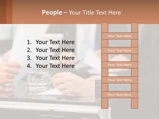 A Group Of People Sitting At A Table Writing On Paper PowerPoint Template