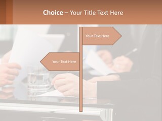 A Group Of People Sitting At A Table Writing On Paper PowerPoint Template