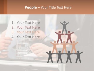 A Group Of People Sitting At A Table Writing On Paper PowerPoint Template