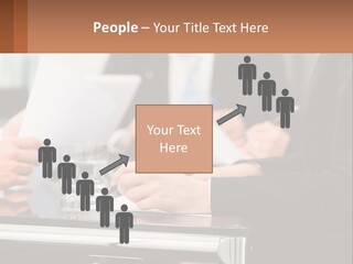A Group Of People Sitting At A Table Writing On Paper PowerPoint Template