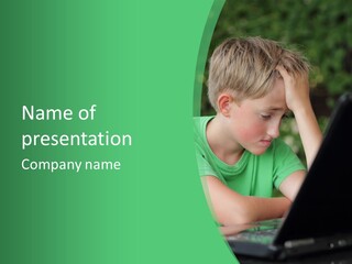 A Young Boy Sitting In Front Of A Laptop Computer PowerPoint Template