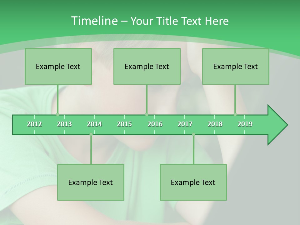 A Young Boy Sitting In Front Of A Laptop Computer PowerPoint Template
