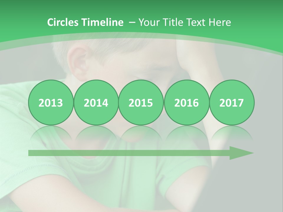 A Young Boy Sitting In Front Of A Laptop Computer PowerPoint Template