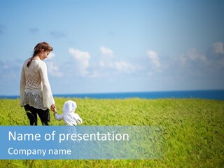 A Woman Holding A Child's Hand In A Field Of Grass PowerPoint Template