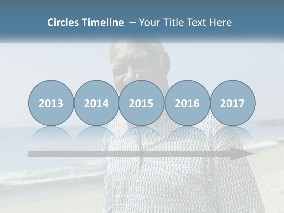 A Man Standing On A Beach With The Ocean In The Background PowerPoint Template