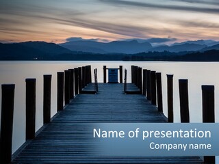 A Wooden Dock With Mountains In The Background PowerPoint Template