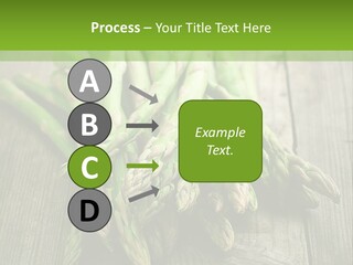 A Pile Of Asparagus On A Wooden Table PowerPoint Template