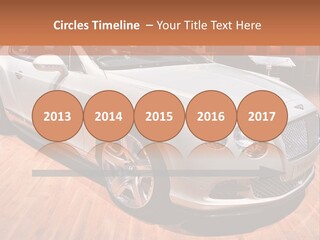 A White Car Is On Display In A Showroom PowerPoint Template