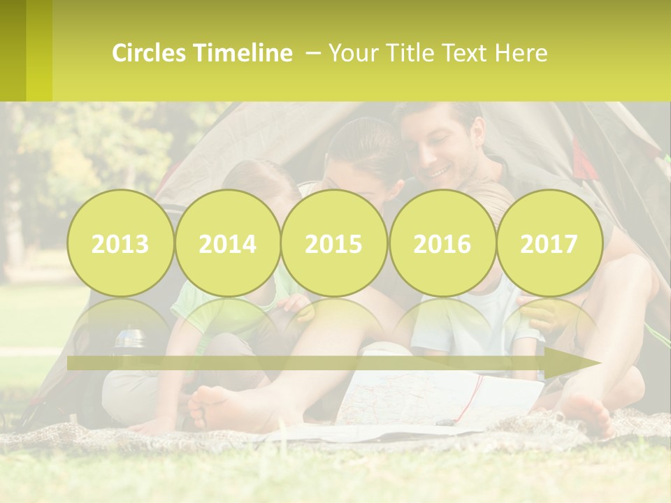 A Family Sitting In Front Of A Tent Reading A Book PowerPoint Template