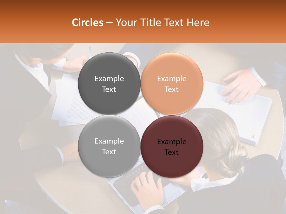 A Group Of People Sitting At A Table Working On Laptops PowerPoint Template