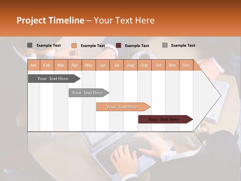 A Group Of People Sitting At A Table Working On Laptops PowerPoint Template