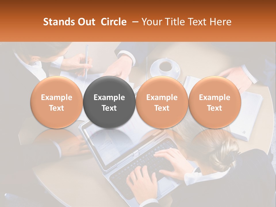 A Group Of People Sitting At A Table Working On Laptops PowerPoint Template