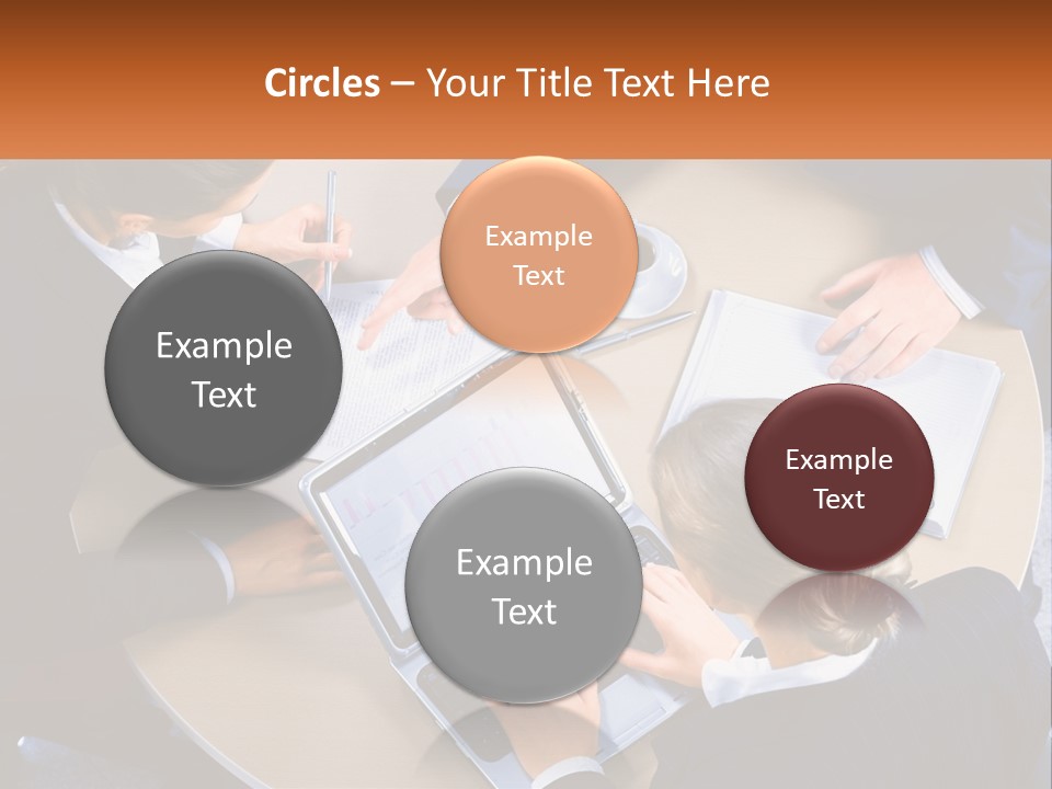 A Group Of People Sitting At A Table Working On Laptops PowerPoint Template