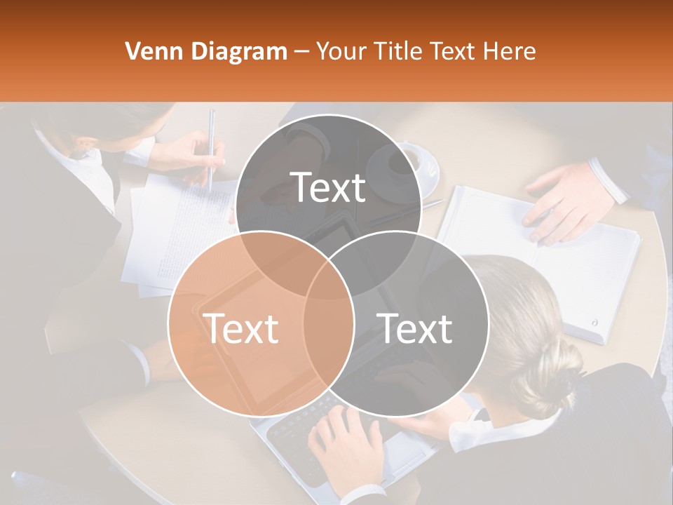 A Group Of People Sitting At A Table Working On Laptops PowerPoint Template