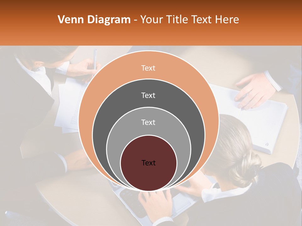 A Group Of People Sitting At A Table Working On Laptops PowerPoint Template