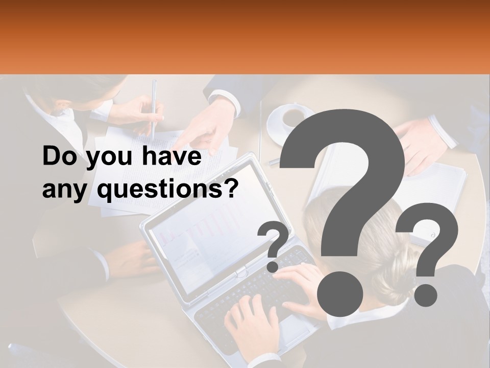 A Group Of People Sitting At A Table Working On Laptops PowerPoint Template