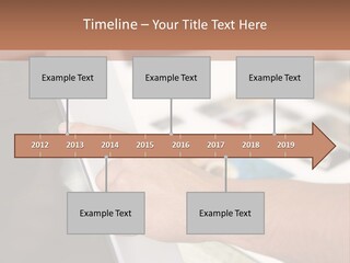 A Person Pointing At A Computer Screen On A Desk PowerPoint Template