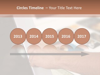 A Person Pointing At A Computer Screen On A Desk PowerPoint Template