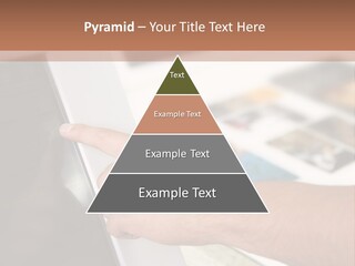 A Person Pointing At A Computer Screen On A Desk PowerPoint Template