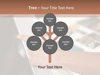 A Person Pointing At A Computer Screen On A Desk PowerPoint Template