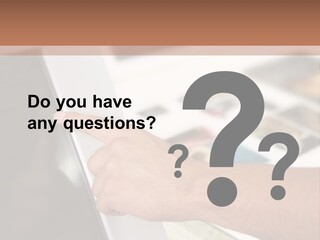 A Person Pointing At A Computer Screen On A Desk PowerPoint Template