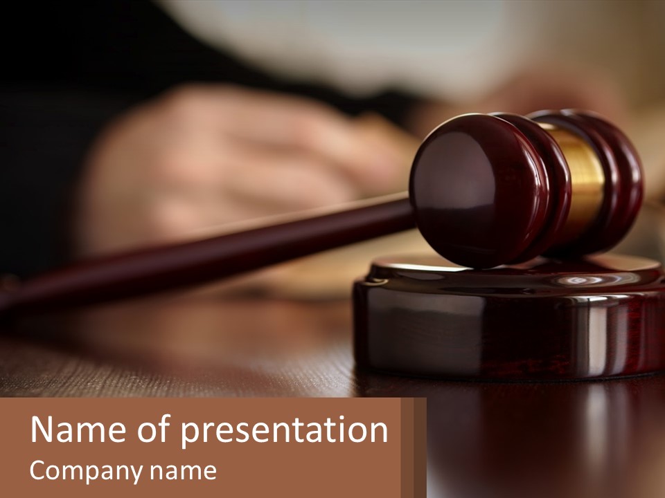 A Wooden Judge's Hammer On Top Of A Wooden Table PowerPoint Template