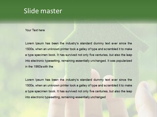 A Person Holding A Small Green House In Their Hands PowerPoint Template