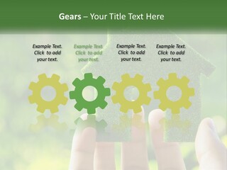A Person Holding A Small Green House In Their Hands PowerPoint Template