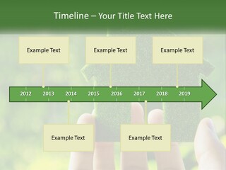 A Person Holding A Small Green House In Their Hands PowerPoint Template