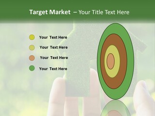 A Person Holding A Small Green House In Their Hands PowerPoint Template
