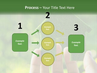 A Person Holding A Small Green House In Their Hands PowerPoint Template