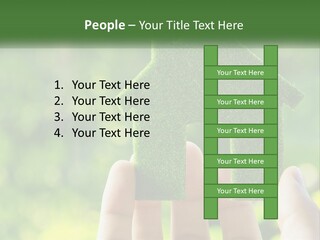 A Person Holding A Small Green House In Their Hands PowerPoint Template